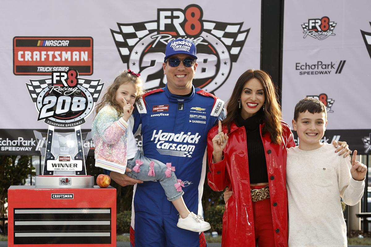 Kyle Busch celebrates with daughter, Lennix Busch, son, Brexton Busch, and wife, Samantha Busch in Victory Lane after winning the NASCAR Craftsman Truck series race at Echo Park Speedway on Feb. 21, 2026, in Hampton, Ga.