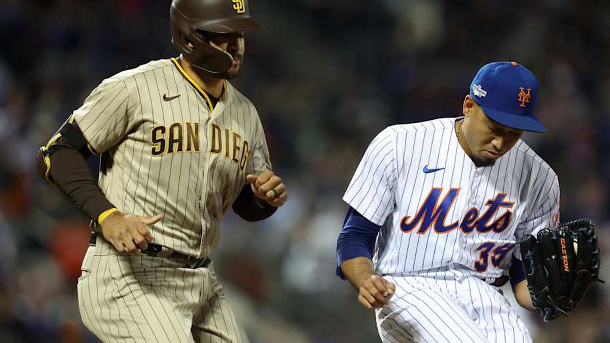  New York Mets relief pitcher Edwin Diaz (39) tags first base ahead of San Diego Padres center fielder Trent Grisham (2) in the seventh inning during game two of the Wild Card series for the 2022 MLB Playoffs at Citi Field. | Brad Penner-Imagn Images 