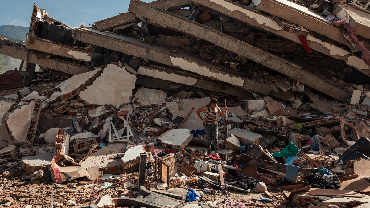 A woman turns away after surveying the wreckage of a seven-story apartment building destroyed by earthquakes in La Guaira, Venezuela, on Thursday, June 25, 2026. More international rescue teams were arriving in Venezuela early Friday to join the urgent effort to retrieve survivors and bodies from the rubble after two powerful earthquakes left at least 235 people dead, thousands injured and several hundred trapped or missing. (Adriana Loureiro Fernandez/The New York Times)