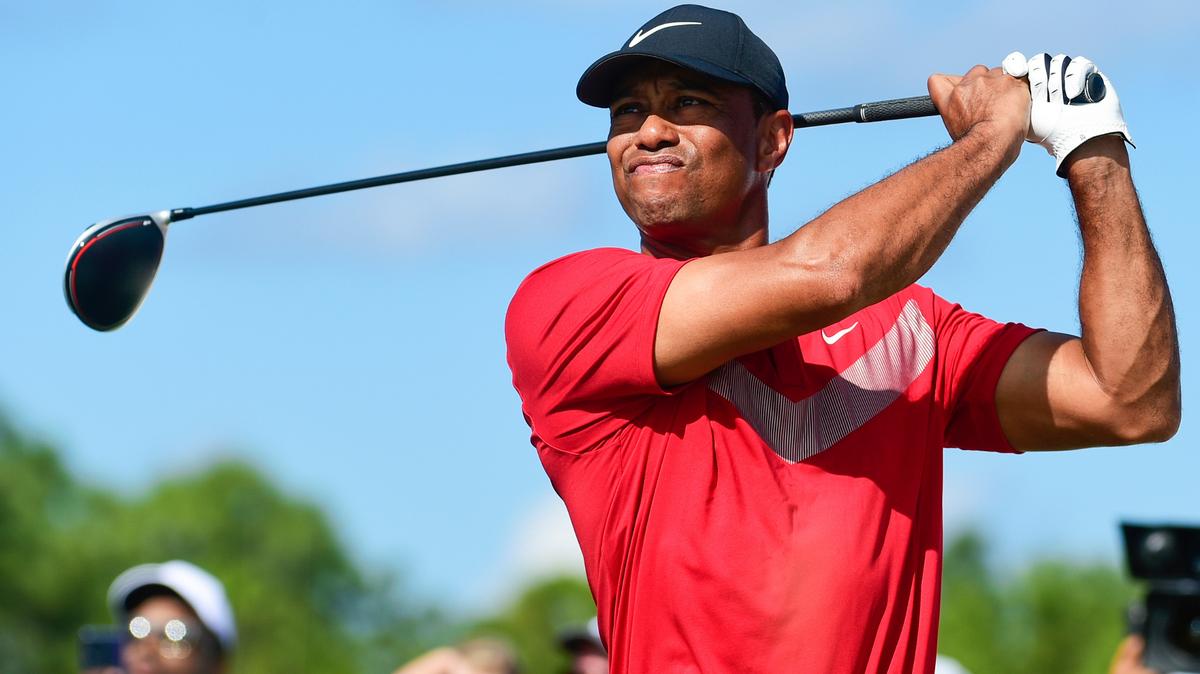 FILE - Tiger Woods follows his ball at the fourth tee during the last round of the Hero World Challenge at Albany Golf Club in Nassau, Bahamas, Saturday, Dec. 7, 2019. Tiger Woods has another loaded field for his Hero World Challenge in the Bahamas. Woods on Tuesday, Oct. 4, 2022, announced 17 players for the 20-man field, and all but four are from the top 21 in the world ranking. Still to be announced is whether the player at No. 1,195 in the world — Woods — will tee it up at Albany.(AP Photo/Dante Carrer, File)