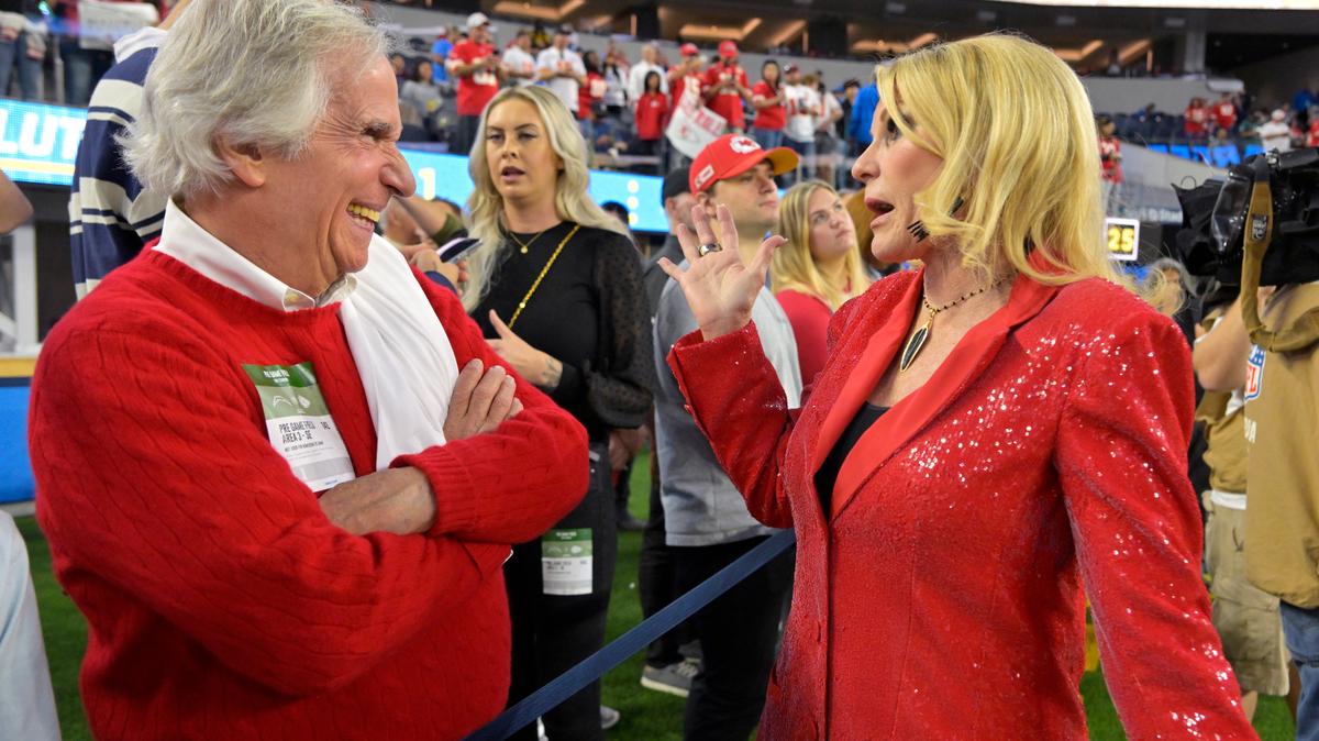 Actor Henry Winkler talks with Tammy Reid, wife of Kansas City coach Andy Reid, before the Nov. 20 Chiefs-Chargers game in Inglewood, Calif.