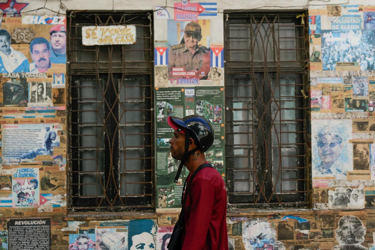 A man walks past an image of former Cuban President Raul Castro, who has been indicted in the United States in a move that marks an escalation in Washington's pressure campaign against the Caribbean island's communist government, Havana, Cuba, May 20, 2026. REUTERS/Norlys Perez