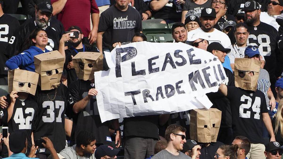  Oct 28, 2018; Oakland, CA, USA; Oakland Raiders fans with paper bags over their heads hold a sign reading \"please trade me!\" during the fourth quarter against the Indianapolis Colts at Oakland Coliseum. Mandatory Credit: Kelley L Cox-Imagn Images | Kelley L Cox-Imagn Images 