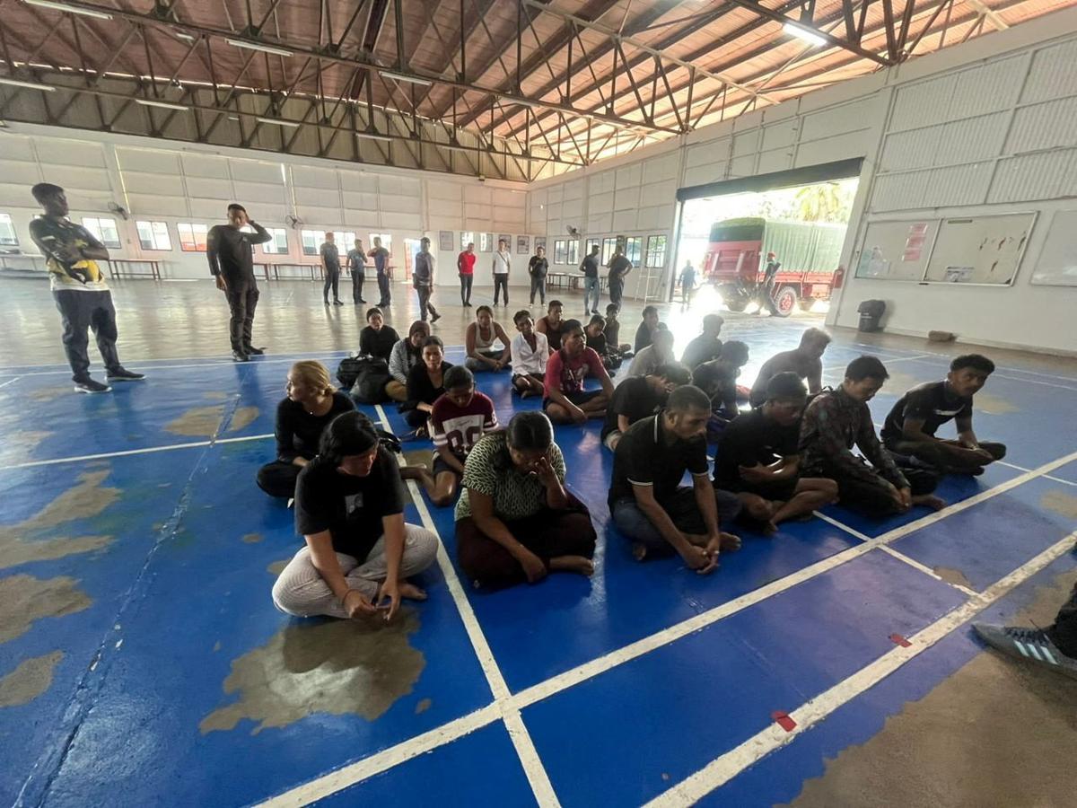 Survivors who were rescued sit after a boat believed to be carrying undocumented Indonesian migrants sank off the coast of Pangkor Island, Malaysia in this undated handout released May 12, 2026. Malaysian Maritime Enforcement Agency/Handout via Reuters