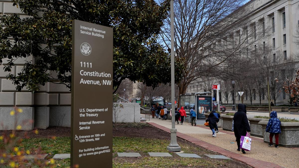 People walk near the International Revenue Service Building in Washington, D.C., U.S., February 18, 2025. REUTERS/Kent Nishimura
