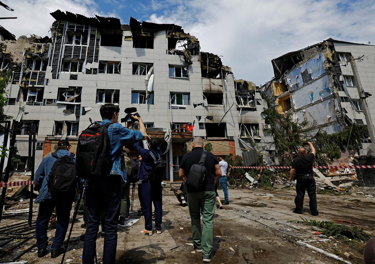 Journalists work near the destroyed dormitory building of the Starobilsk College of Luhansk Pedagogical University following a recent attack, which Russian authorities called a Ukrainian drone strike, in the course of the Russia-Ukraine conflict in the town of Starobilsk (Starobelsk) in the Luhansk region, a Russian-controlled area of Ukraine, May 24, 2026. Reuters reported from Starobilsk on a media facility trip organised by the Ministry of Foreign Affairs of the Russian Federation on May 24, 2026. REUTERS/Alexander Ermochenko