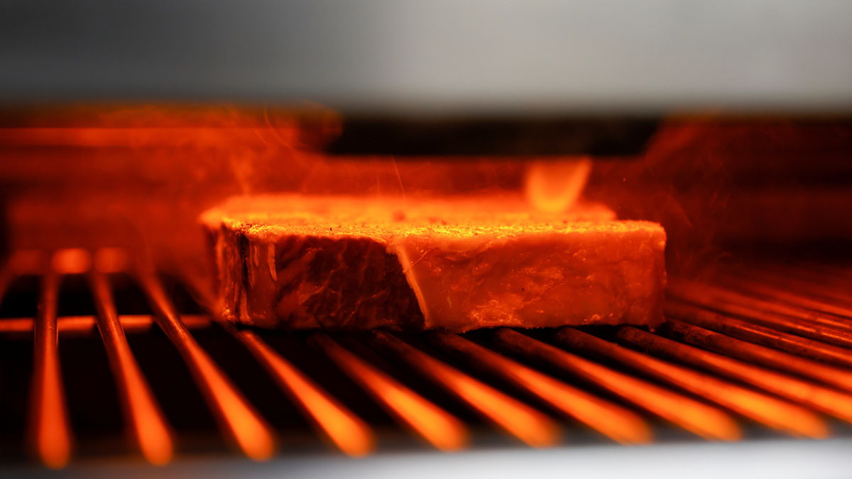 Beef steaks get cooked at the kitchen of Wolfgang