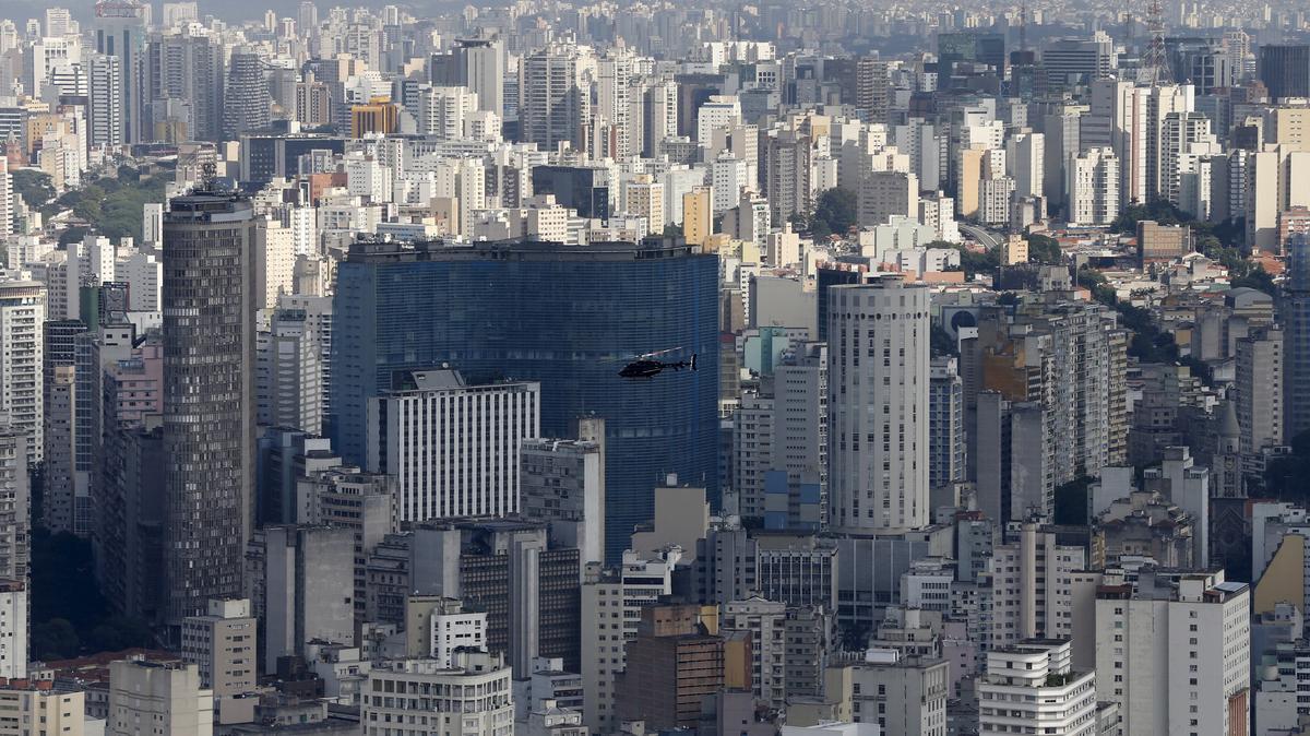 A helicopter flies over the skyline of Sao Paulo April 2, 2015. REUTERS/Paulo Whitaker