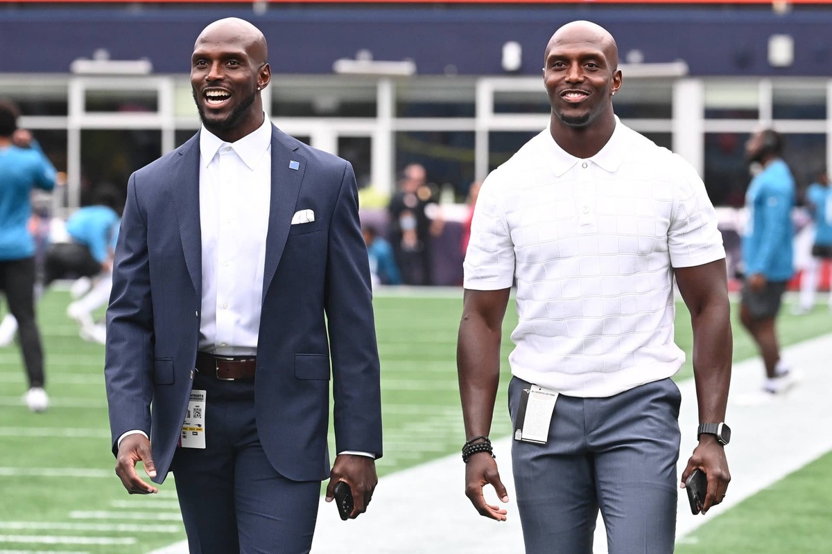  August 8, 2024; Foxborough, MA, USA; Former New England Patriots defensive players Jason McCourty (l) and twin brother Devin McCourty (r) walk the sideline before a game against the Carolina Panthers at Gillette Stadium. Mandatory Credit: Eric Canha-USA TODAY Sports 