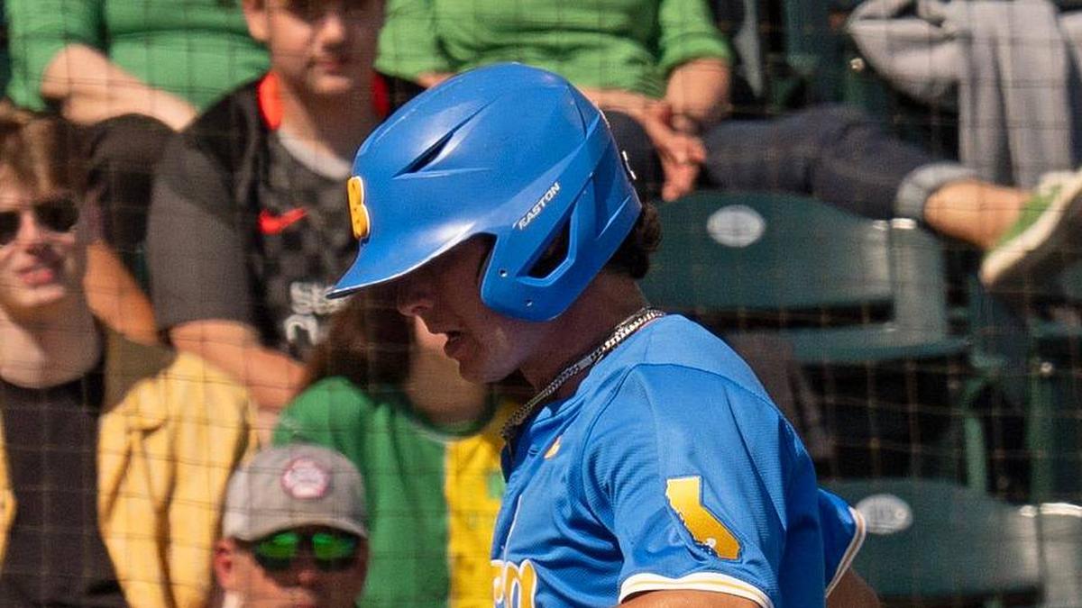  UCLA's Roch Cholowsky, left, scores a run on a wild pitch by Oregon pitcher Collin Clarke during the 4th inning at PK Park in Eugene April 19, 2025 | Chris Pietsch/The Register-Guard / USA TODAY NETWORK via Imagn Images 