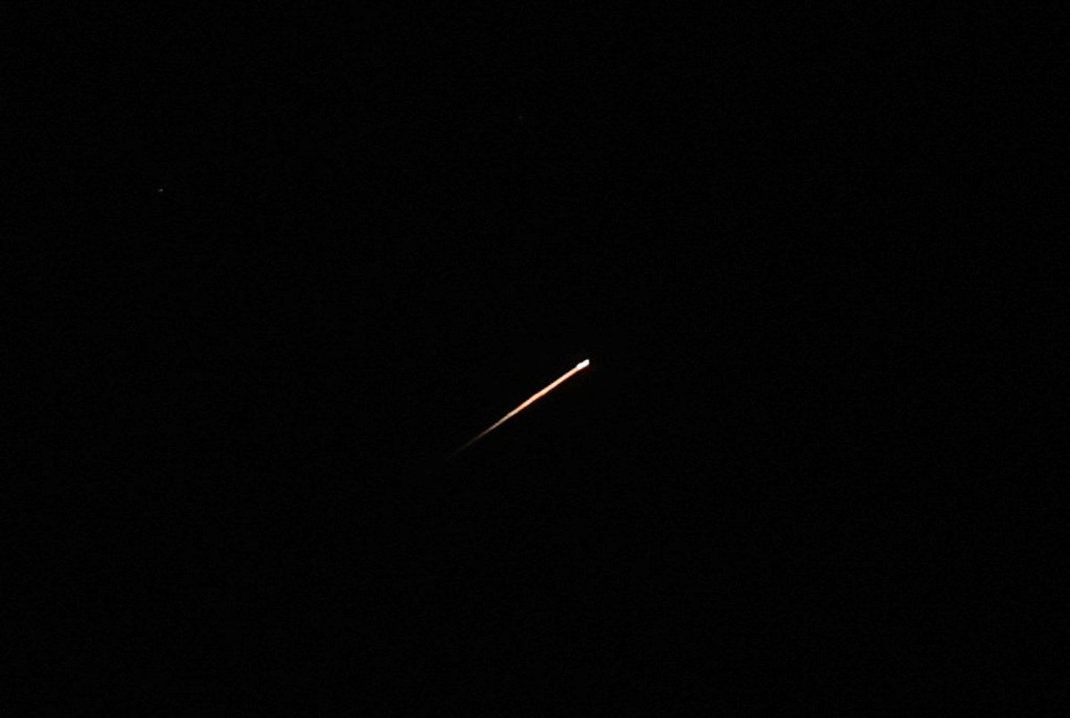 A streak of light illuminates the sky during a missile attack from Iran towards Israel, as seen from Jerusalem, June 7, 2026. REUTERS/Ammar Awad