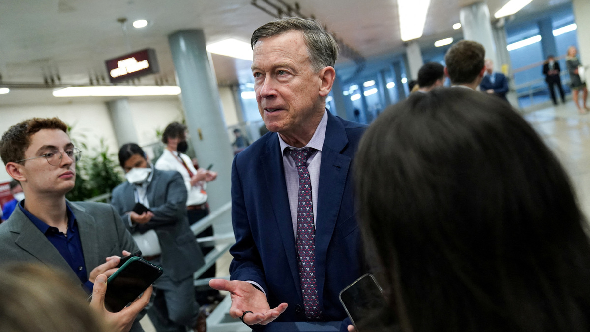 FILE PHOTO: U.S. Senator John Hickenlooper (D-CO) speaks to members of the press while passing through the Senate subway at the U.S. Capitol in Washington, D.C., U.S., July 19, 2022. REUTERS/Sarah Silbiger/File Photo