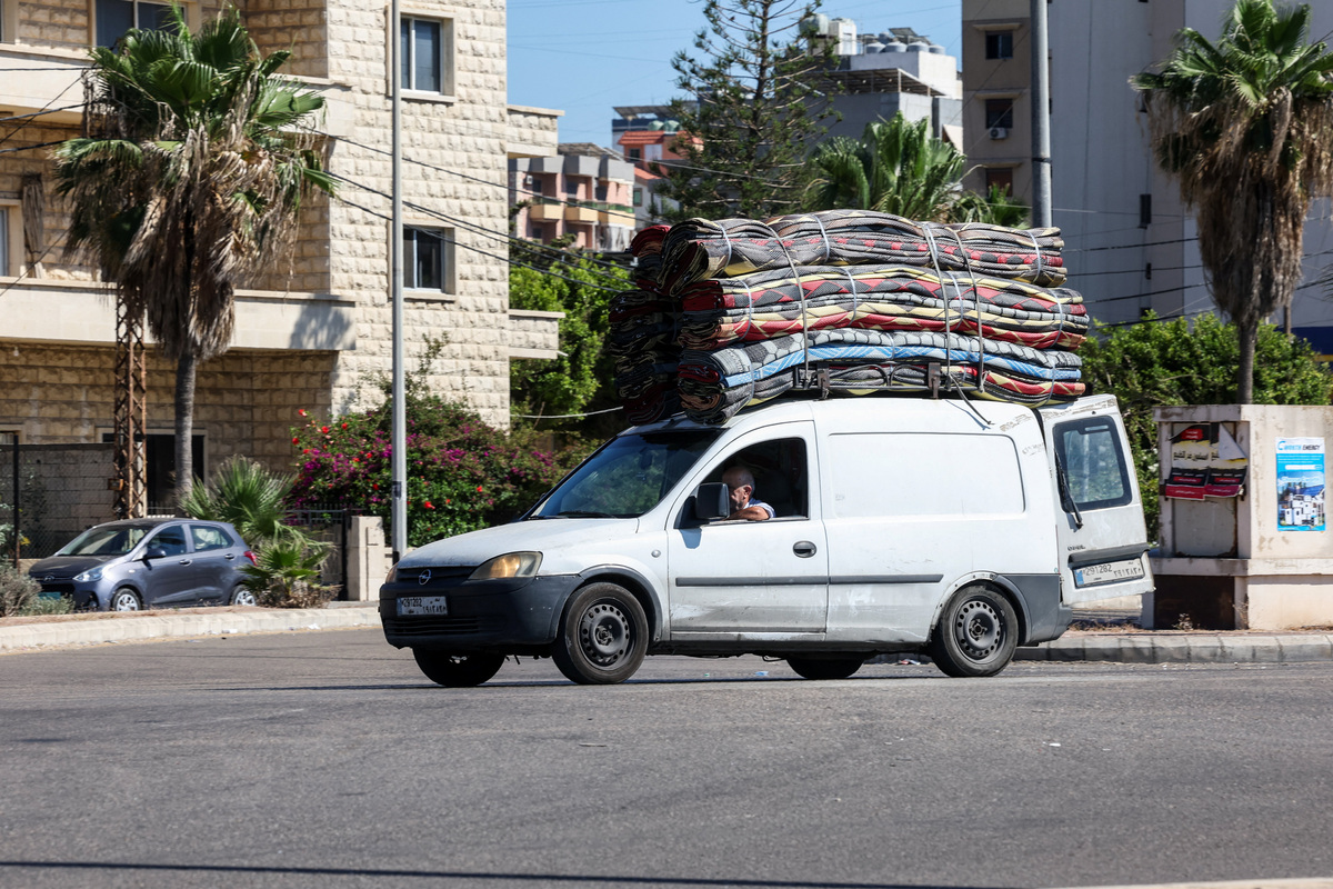 A man sits inside a vehicle loaded with belongings, on the outskirts of Sidon, Lebanon, June 19, 2026. REUTERS/Aziz Taher