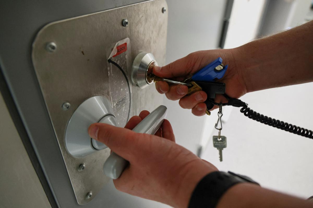 Gabriel Wessman, Director of Rosersberg Prison, unlocks a cell being rebuilt to house teenage offenders in Rosersberg Prison, near Stockholm, Sweden, May 25, 2026. REUTERS/Tom Little