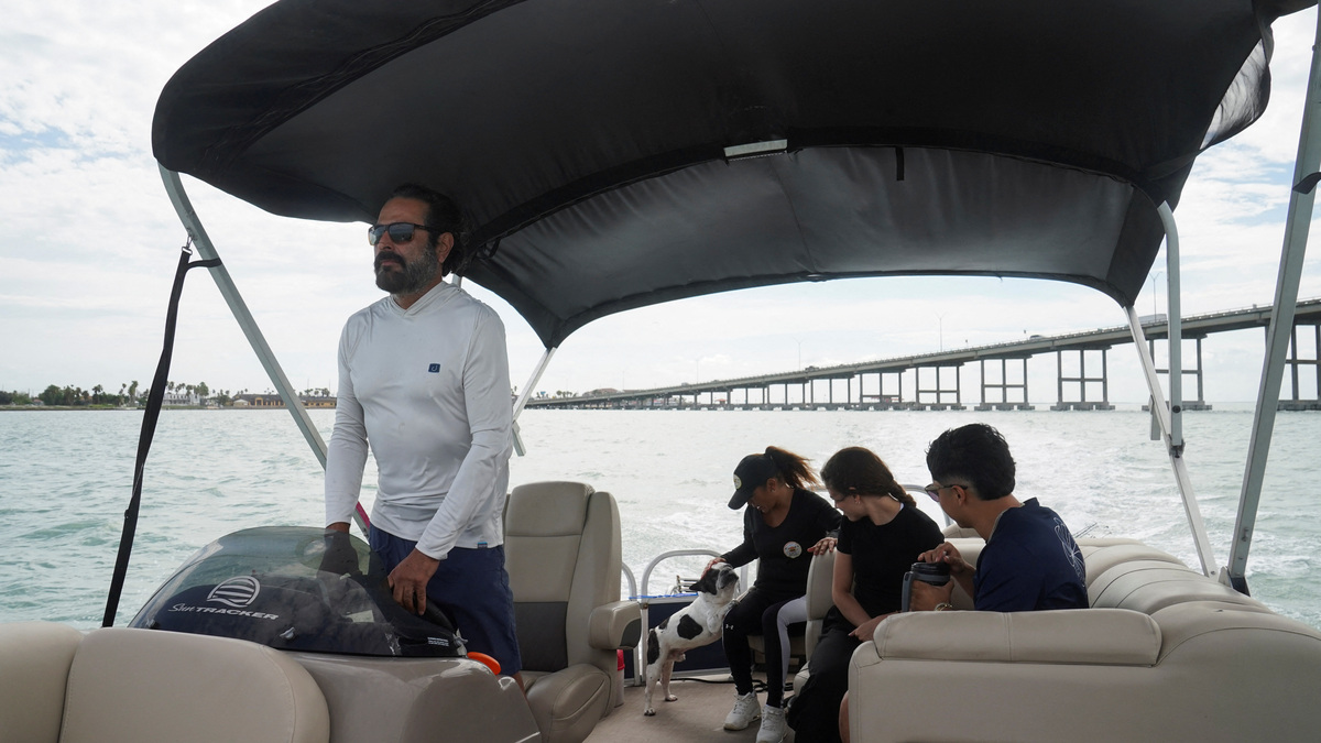 Eddie Reyes, his wife Liliana Pena, Viviana Espinoza, and Kriz Pena make their way to fish as they see SpaceX's rocket launch ahead of the company's initial public offering (IPO), in Port Isabel, Texas, U.S.  May 21, 2026.  REUTERS/Gabriel V. Cardenas