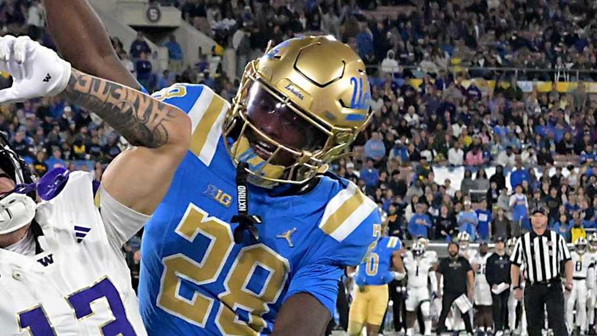  Nov 22, 2025; Pasadena, California, USA; UCLA Bruins defensive back Scooter Jackson (28) breaks up a pass intended for Washington Huskies wide receiver Audric Harris (13) in the end zone during the first half at the Rose Bowl. Mandatory Credit: Jayne Kamin-Oncea-Imagn Images | Jayne Kamin-Oncea-Imagn Images 