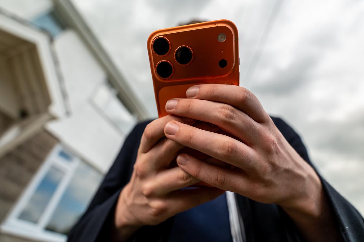  A person is seen holding an iPhone on May 6 in Bath, England. (Photo Illustration by Anna Barclay/Getty Images) 