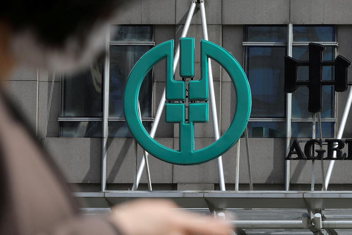 FILE PHOTO: A sign of Agricultural Bank of China is seen at its office building in Beijing, China March 29, 2021. REUTERS/Tingshu Wang/File Photo