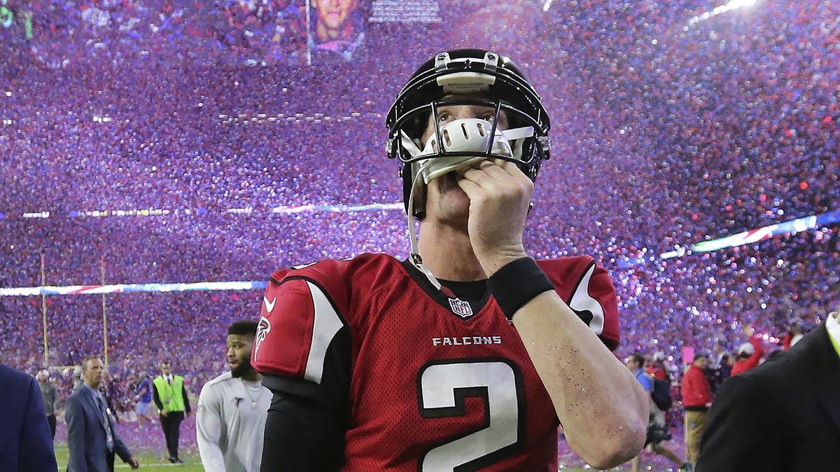 FILE - In this Feb. 5, 2017, file photo, , Atlanta Falcons quarterback Matt Ryan reacts after losing Super Bowl 51 as the screen flashes New England Patriots quarterback Tom Brady and confetti flies in Houston. As the World Series comes to Atlanta for the first time since 1999, there is hope that the city — once immortalized by Sports Illustrated as “Loserville” — and the entire state of Georgia, for that matter, could be taking a turn toward some long-overdue parades and celebrations. (Curtis Compton/Atlanta Journal-Constitution via AP, File)
