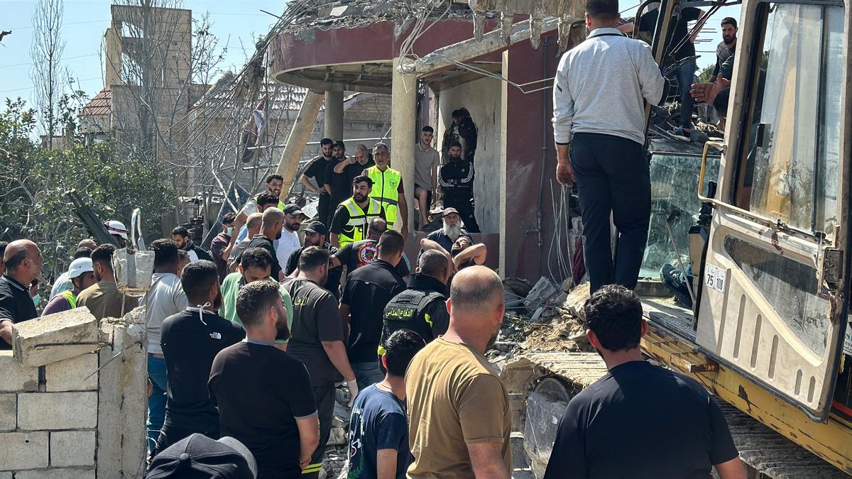 Emergency responders assisted by other people and heavy machinery inspect the site of an Israeli strike in Saksakiyeh, Lebanon, May 9, 2026. Picture taken with a mobile phone. REUTERS/Stringer