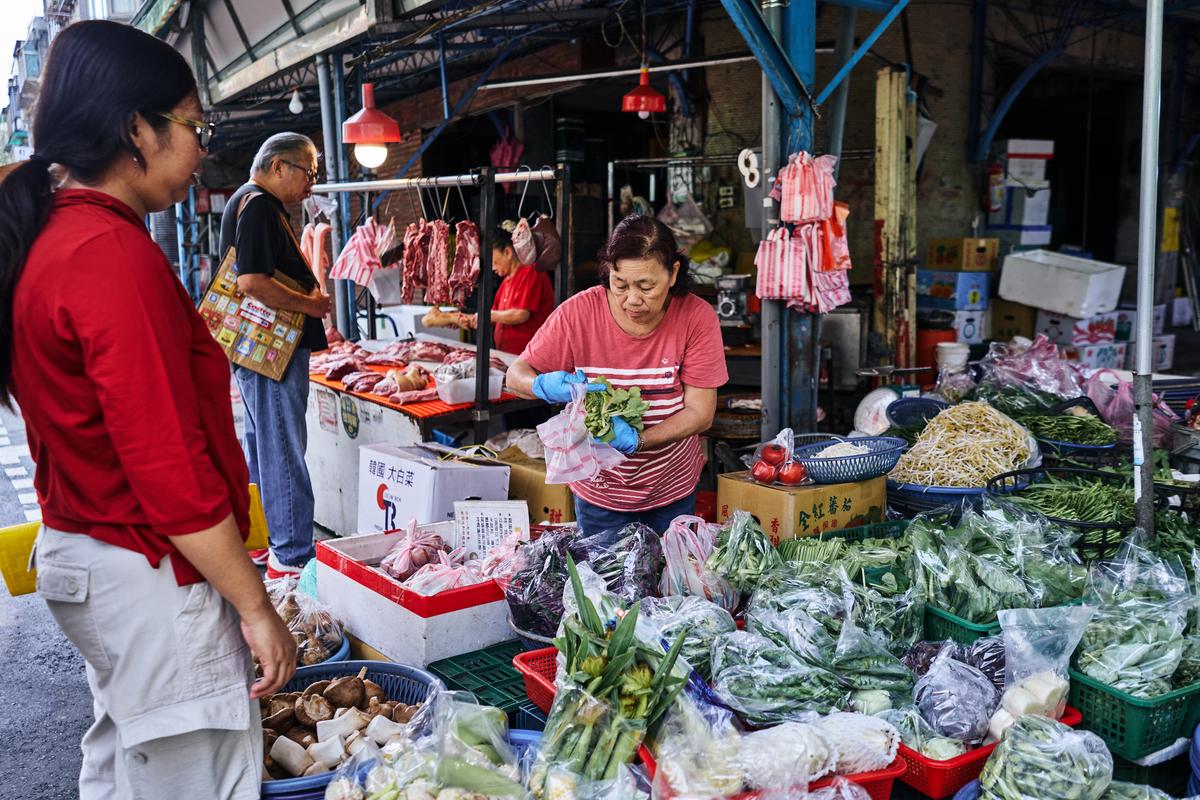 People shop the Xizhou Public Market in Taipei, Taiwan on April 9, 2026. Plastic producers in Taiwan have scrambled to secure new supplies since the war in Iran disrupted petrochemical flows and tightened availability. (An Rong Xu/The New York Times)