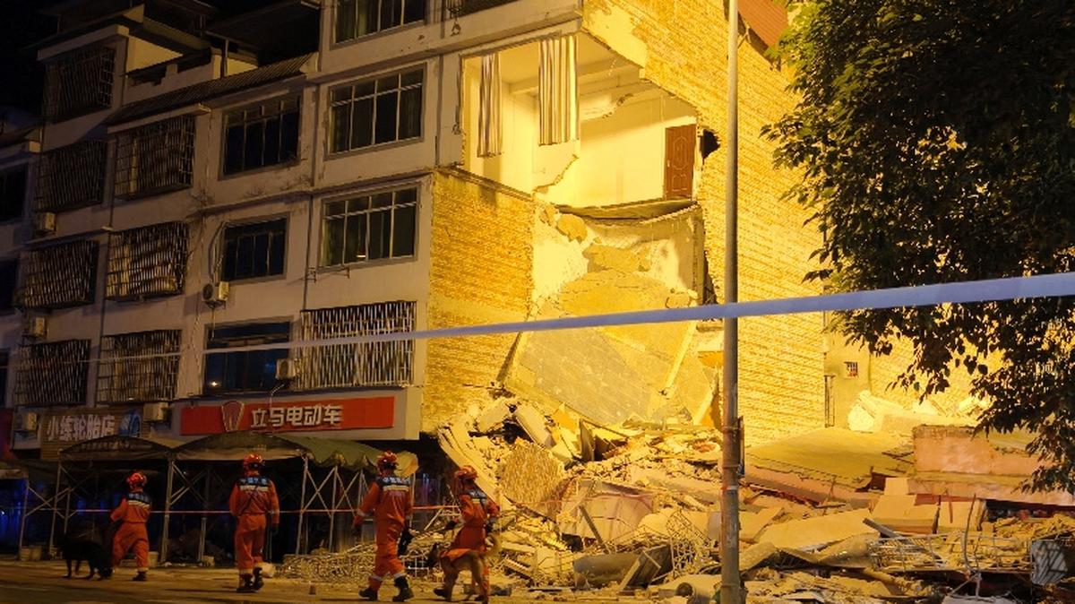 Rescue workers walk past a damaged building following an earthquake at Taiyang village in Liuzhou, Guangxi Zhuang Autonomous Region, China May 18, 2026. cnsphoto via REUTERS