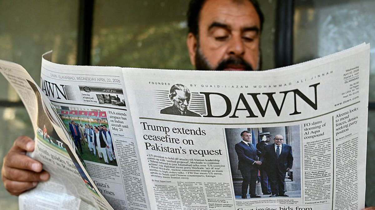 A man reads a newspaper with a front page article referring to anticipated U.S.-Iran peace talks at a stall on Wednesday in Islamabad, Pakistan, which is set to host the negotiations. 