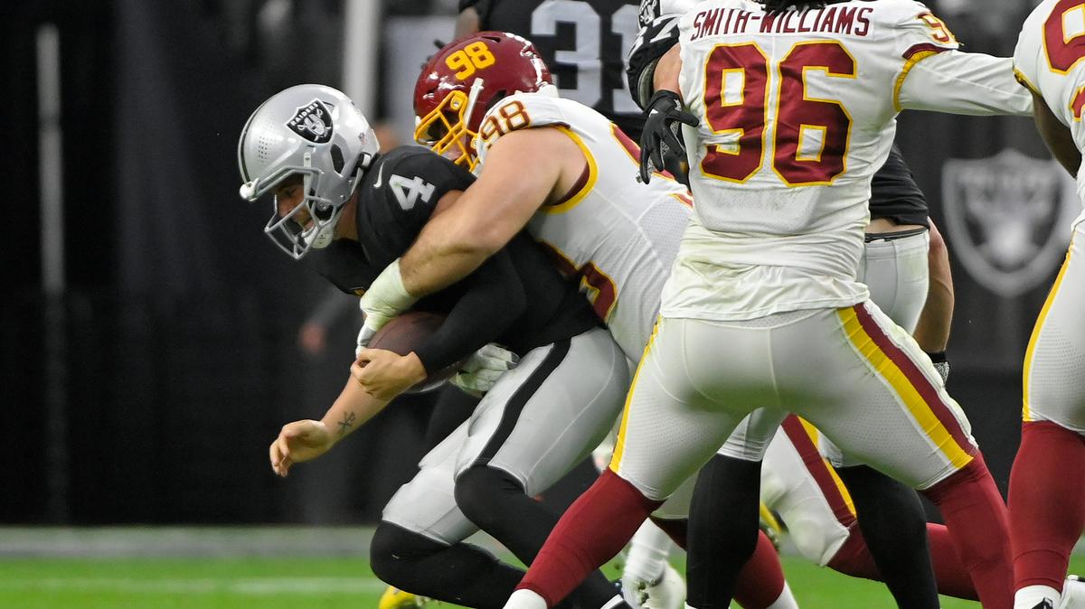Washington Football Team defensive tackle Matthew Ioannidis (98) sacks Las Vegas Raiders quarterback Derek Carr (4) during the second half of an NFL football game, Sunday, Dec. 5, 2021, in Las Vegas. (AP Photo/David Becker)