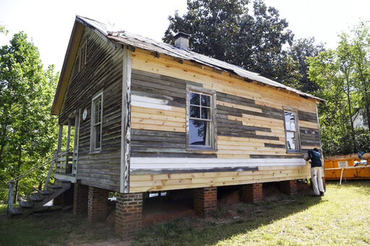 Tyle Woodard, 17, paints the birthplace of Nina Simone in Tryon, N.C., on May 2. The nearly 90-year-old home where Simone grew up in Tryon, north of the city’s downtown, is being stabilized after years of neglect that nearly saw the structure be demolished. Workers from the National Trust for Historic Preservation’s HOPE Crew have replaced and painted siding on the 660-square-foot structure ahead of additional work on windows, interior and the roof.