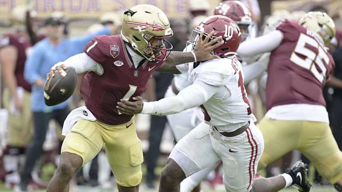  Aug 30, 2025; Tallahassee, Florida, USA; Florida State Seminoles quarterback Tommy Castellanos (1) stiff arms Alabama Crimson Tide linebacker Justin Jefferson (10) during the second half at Doak S. Campbell Stadium. Mandatory Credit: Melina Myers-Imagn Images | Melina Myers-Imagn Images 