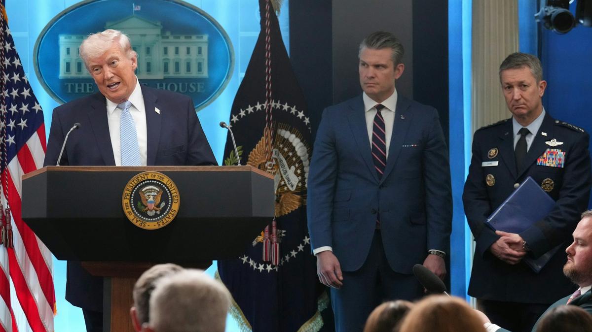 President Donald Trump speaks during a news conference at the White House on April 6, 2026, in Washington, as Defense Secretary Pete Hegseth and Chairman of the Joint Chiefs of Staff Gen. Dan Caine listen. AP Photo/Mark Schiefelbein, File. 