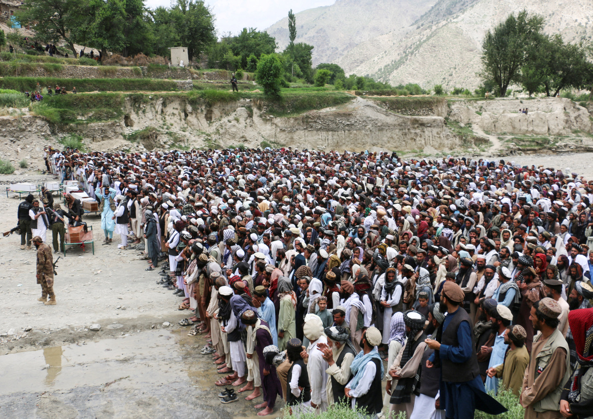 People offer funeral prayers as they gather near coffins containing the bodies of victims who died in what the Taliban said was a Pakistani airstrike in Mani village, Spera District, Khost Province, Afghanistan, June 10, 2026. REUTERS/Stringer