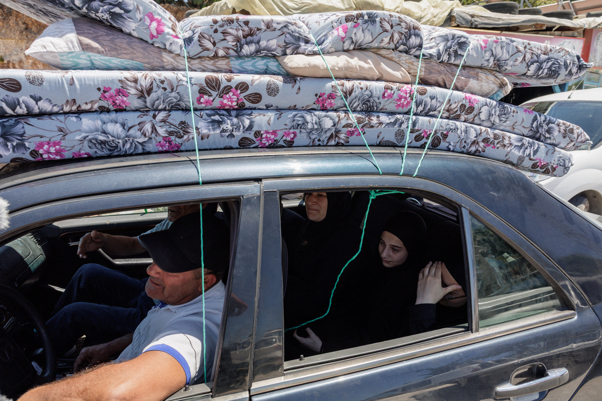 A family with belongings loaded on their car, fleeing southern Lebanon again, heads North after returning following the U.S.-Iran deal, as overnight fighting between Israeli forces and Hezbollah resumes, on the outskirts of Tyre, in southern Lebanon June 19, 2026.REUTERS/Zohra Bensemra