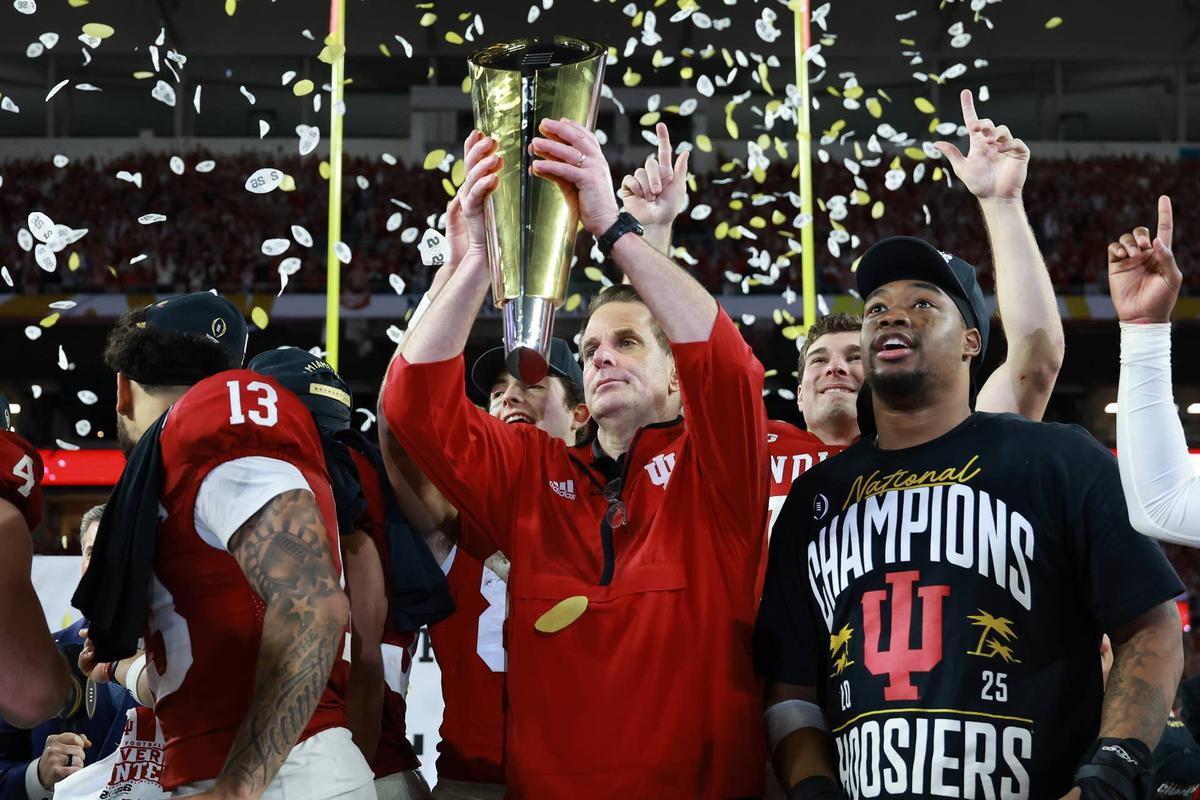  Jan 19, 2026; Miami Gardens, FL, USA; Indiana Hoosiers head coach Curt Cignetti hoists the National Championship trophy in the air after the College Football Playoff National Championship game at Hard Rock Stadium. Mandatory Credit: Mark J. Rebilas-Imagn Images 