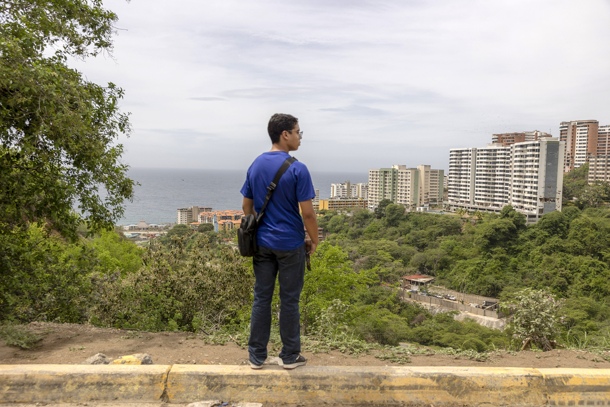 A family member waits outside the Hotel Santuario La Llanada, where deportees were held, in La Guaira, Venezuela, on Tuesday, June 30, 2026. Many of the 146 Venezuelans deported from the United States were at this state-run holding facility the day the earthquakes struck and are now feared dead. (Fabiola Ferrero/The New York Times)