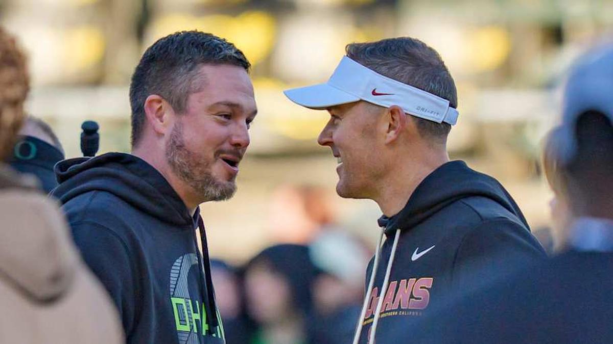  Oregon head coach Dan Lanning, left, and USC head coach Lincoln Riley shake hands before the game as the Oregon Ducks host the USC Trojans on Nov. 22, 2025, at Autzen Stadium in Eugene, Oregon. | Ben Lonergan/The Register-Guard / USA TODAY NETWORK via Imagn Images 