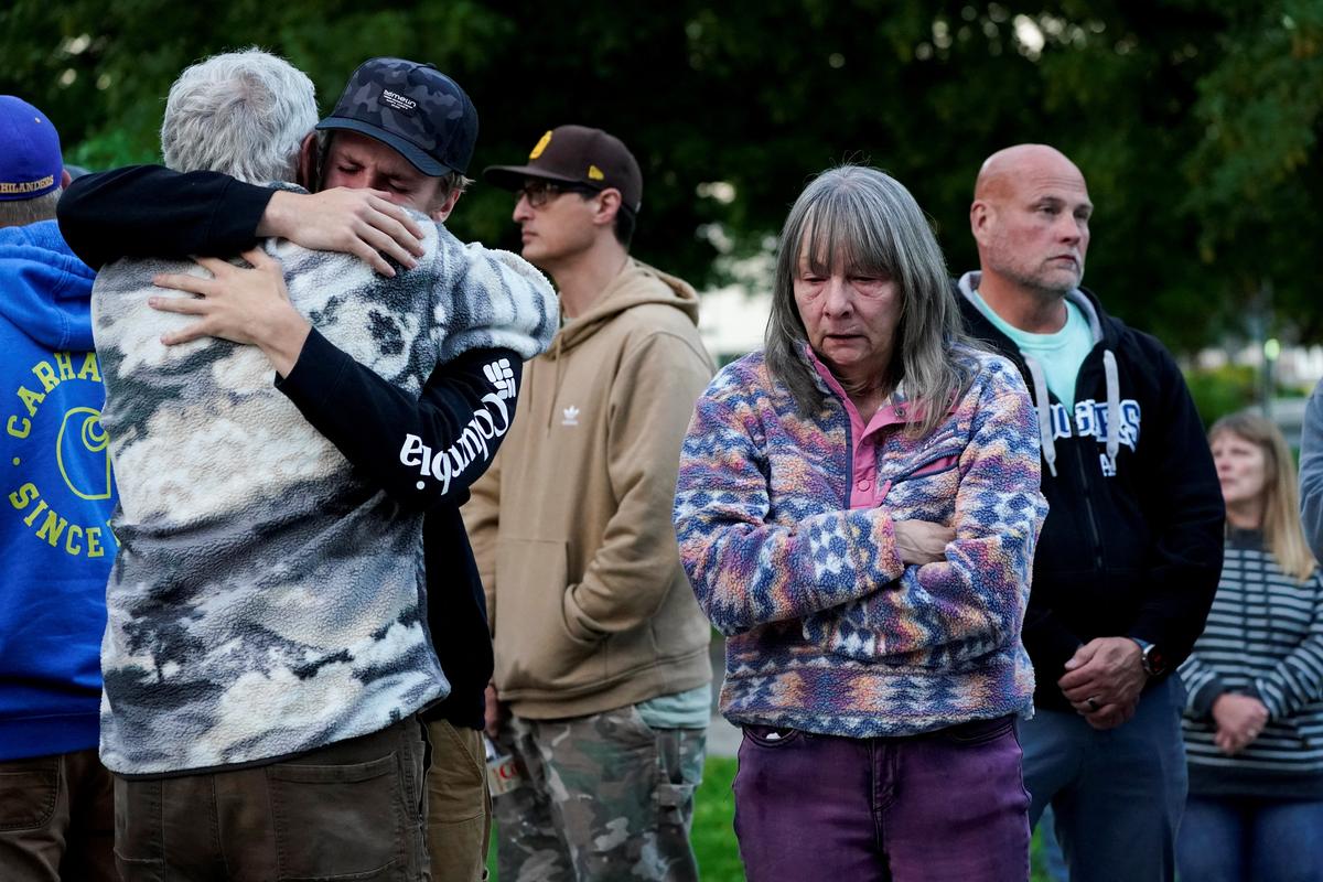 People embrace as they attend a vigil after a chemical tank rupture at the Nippon Dynawave Packaging pulp and paper mill, in Longview, Washington, U.S., May 26, 2026.  REUTERS/David Ryder