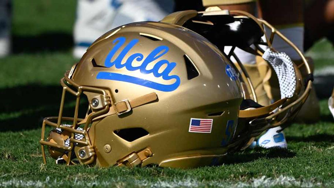 Nov 30, 2024; Pasadena, California, USA; UCLA Bruins helmets during pregame warmups before playing the Fresno State Bulldogs at Rose Bowl. Mandatory Credit: Robert Hanashiro-Imagn Images | Robert Hanashiro-Imagn Images 
