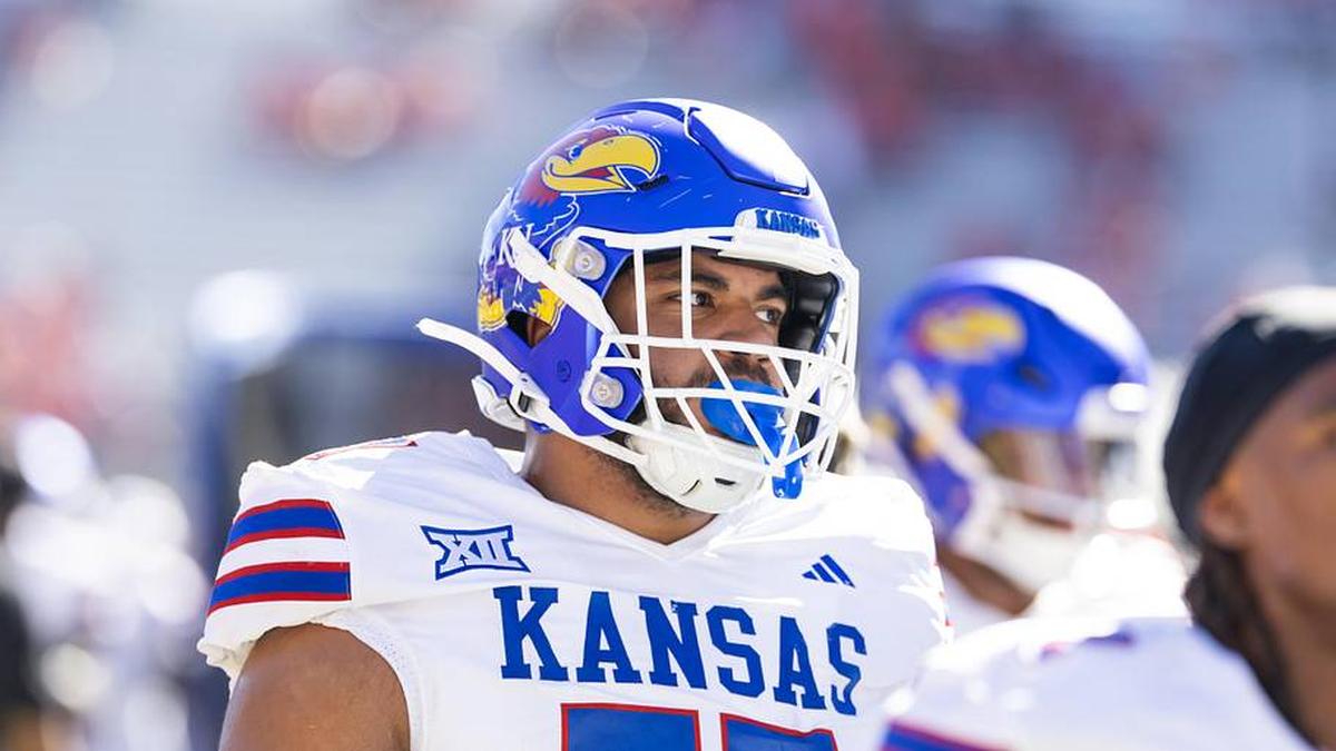  Nov 8, 2025; Tucson, Arizona, USA; Kansas Jayhawks offensive lineman Enrique Cruz Jr. (77) against the Arizona Wildcats at Arizona Stadium. Mandatory Credit: Mark J. Rebilas-Imagn Images | Mark J. Rebilas-Imagn Images 