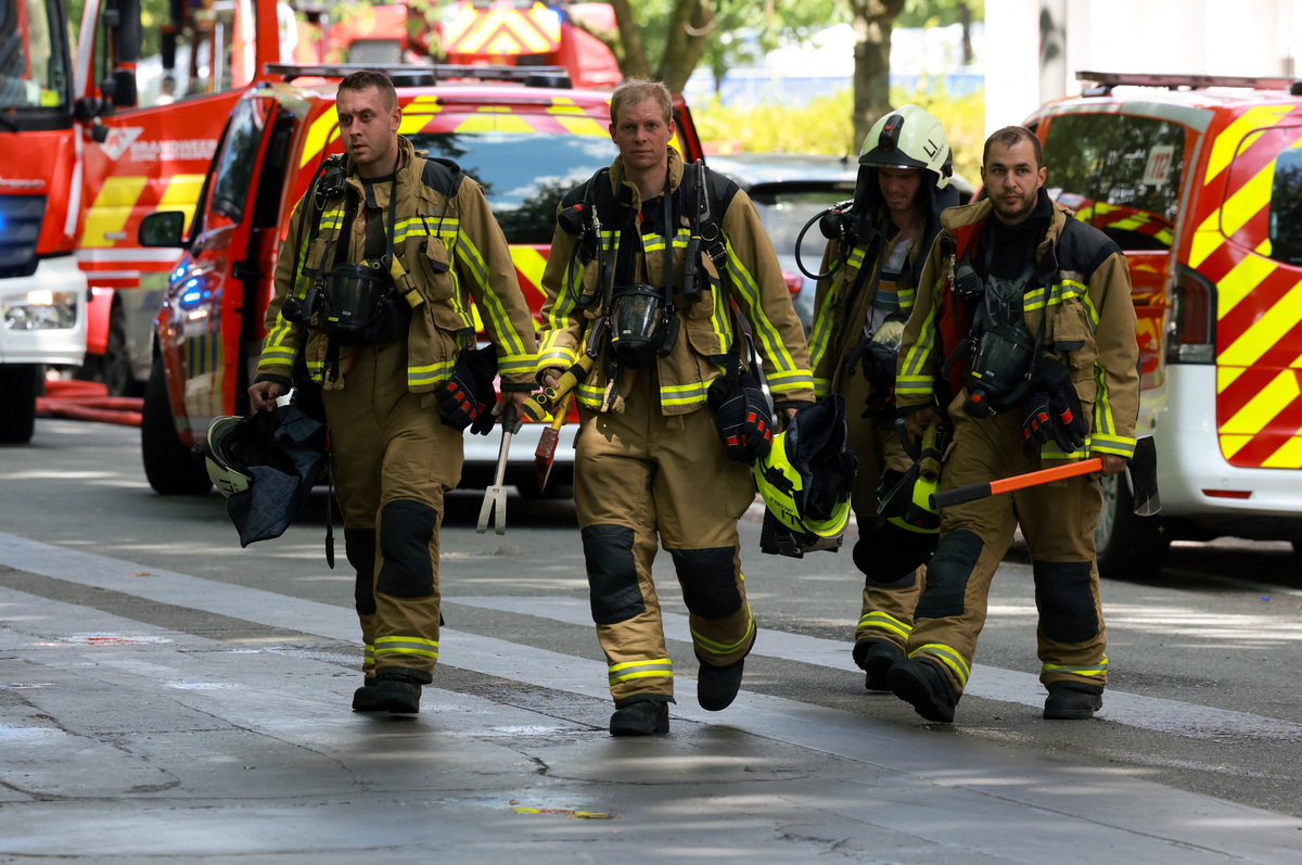Firefighters work at the site of a fire in a housing building in Antwerp, Belgium, July 1, 2026. REUTERS/Yves Herman