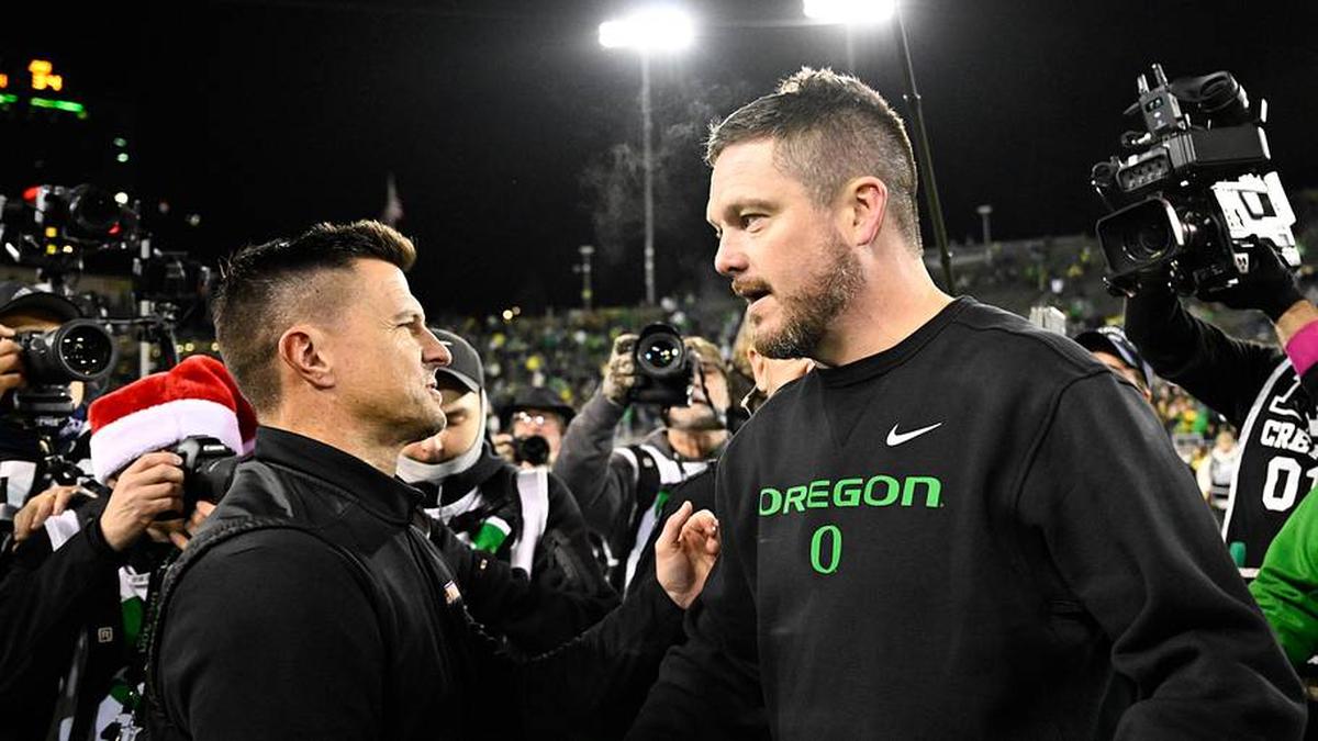  Dec 20, 2025; Eugene, OR, USA; James Madison Dukes head coach Bob Chesney and Oregon Ducks head coach Dan Lanning greet one another after the game at Autzen Stadium. Mandatory Credit: Troy Wayrynen-Imagn Images | Troy Wayrynen-Imagn Images 