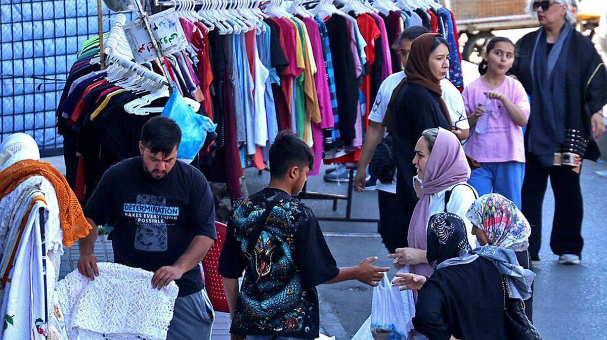 People shop at a market in Sadeghiyeh Square in Tehran, Iran, on Sunday. Iran’s chief negotiator said that Tehran would not agree to any deal with the United States unless it fully secures Iranian rights, as reports emerged that Washington had sent a tougher peace proposal back to Iran.