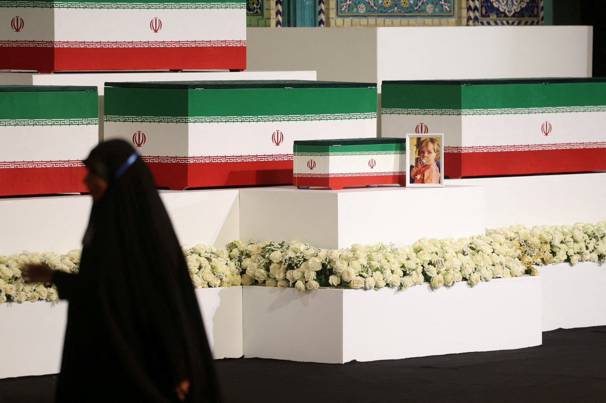 A picture of Zahra Mohammadi Golpayegani, granddaughter of Iran's late Supreme Leader Ayatollah Ali Khamenei, is displayed near the coffins of Khamenei and his family members on the day international delegates participate in a farewell ceremony for Khamenei, who was killed on February 28 during Israeli and U.S. airstrikes on Iran, at the Imam Khomeini Grand Mosalla in Tehran, Iran July 3, 2026. REUTERS/Mohammed Salem