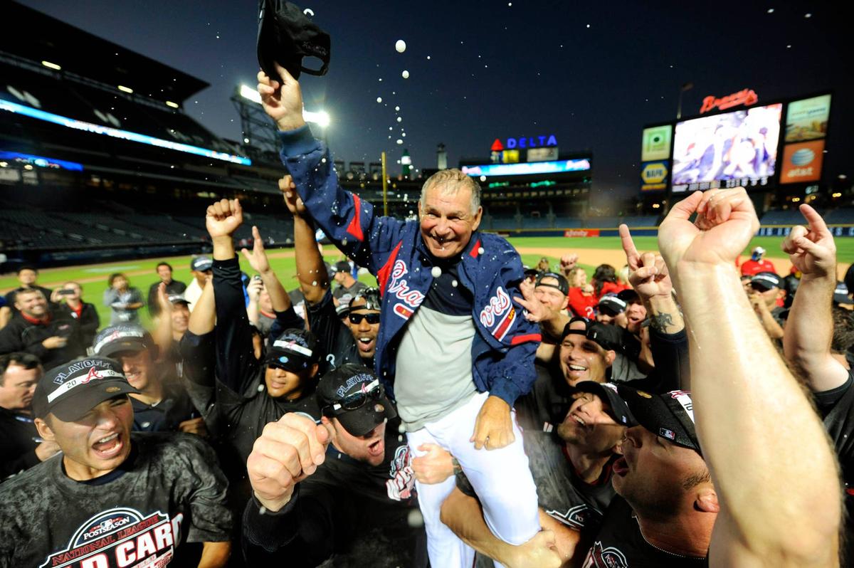  October 3, 2010; Atlanta, GA, USA; Atlanta Braves manager Bobby Cox (6) gets hoisted on the shoulders of his players as they celebrate on the field following San Francisco Giants victory over San Diego Padres allowing the Braves to clinch the wildcard after defeating the Philadelphia Phillies earlier 8-7 at Turner Field. Mandatory Credit: John David Mercer-USA TODAY Sports 