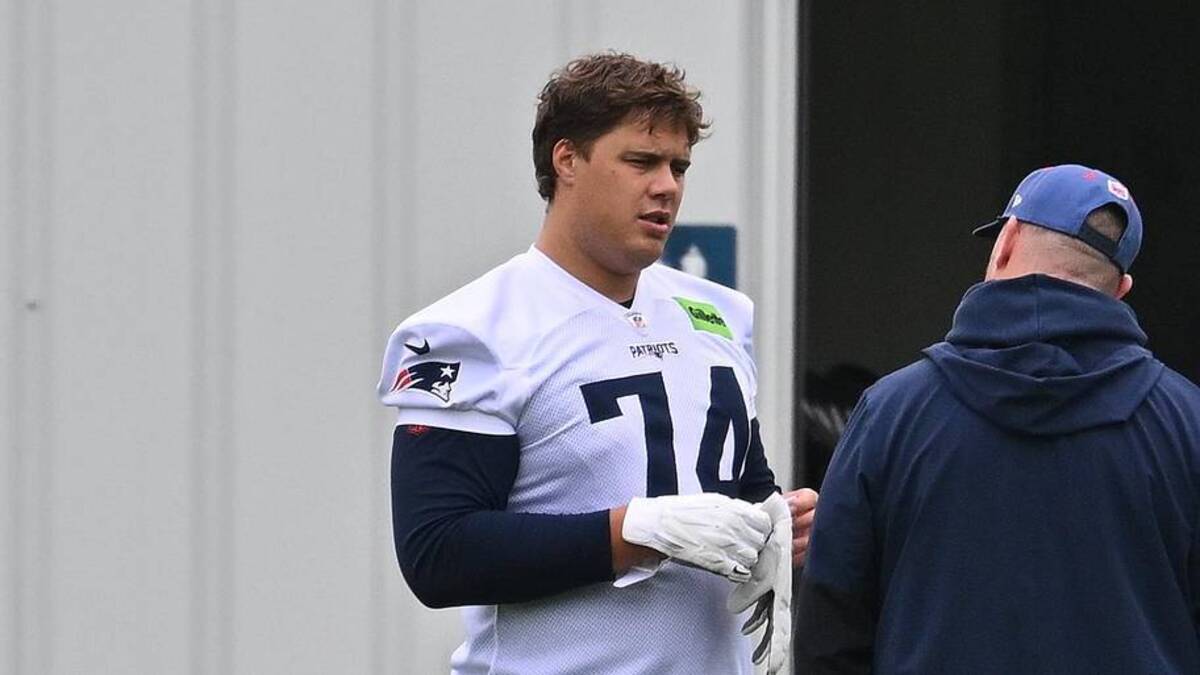  May 9, 2026; Foxborough, MA, USA; New England Patriots rookie tackle Caleb Lomu (74) talks to a member of the coaching staff at the New England Patriots rookie camp at Gillette Stadium. Mandatory Credit: Eric Canha-Imagn Images | Eric Canha-Imagn Images 