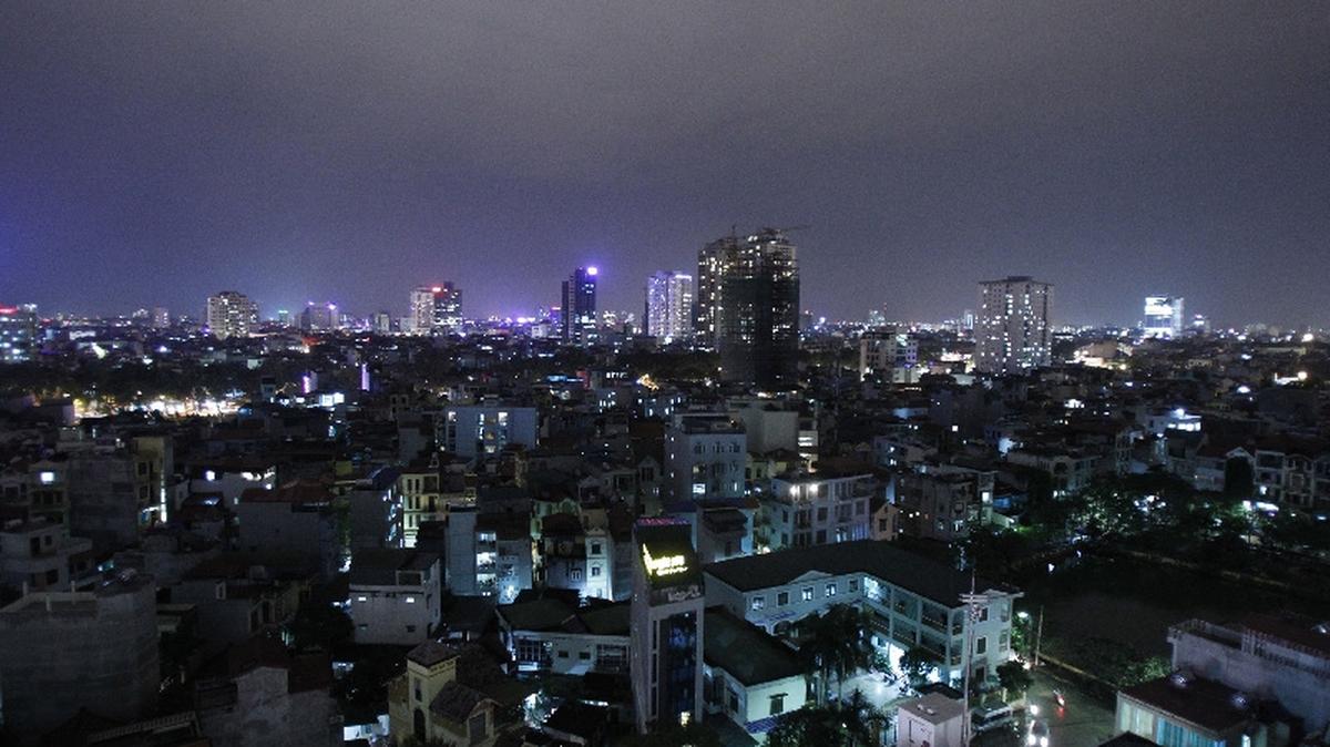 The skyline of Hanoi is seen from a building at night December 1, 2011. The country's population density is nearly 260 people for each square km, six times above the world's average, the local media said on Wednesday. REUTERS/Kham (VIETNAM - Tags: CITYSPACE SOCIETY)