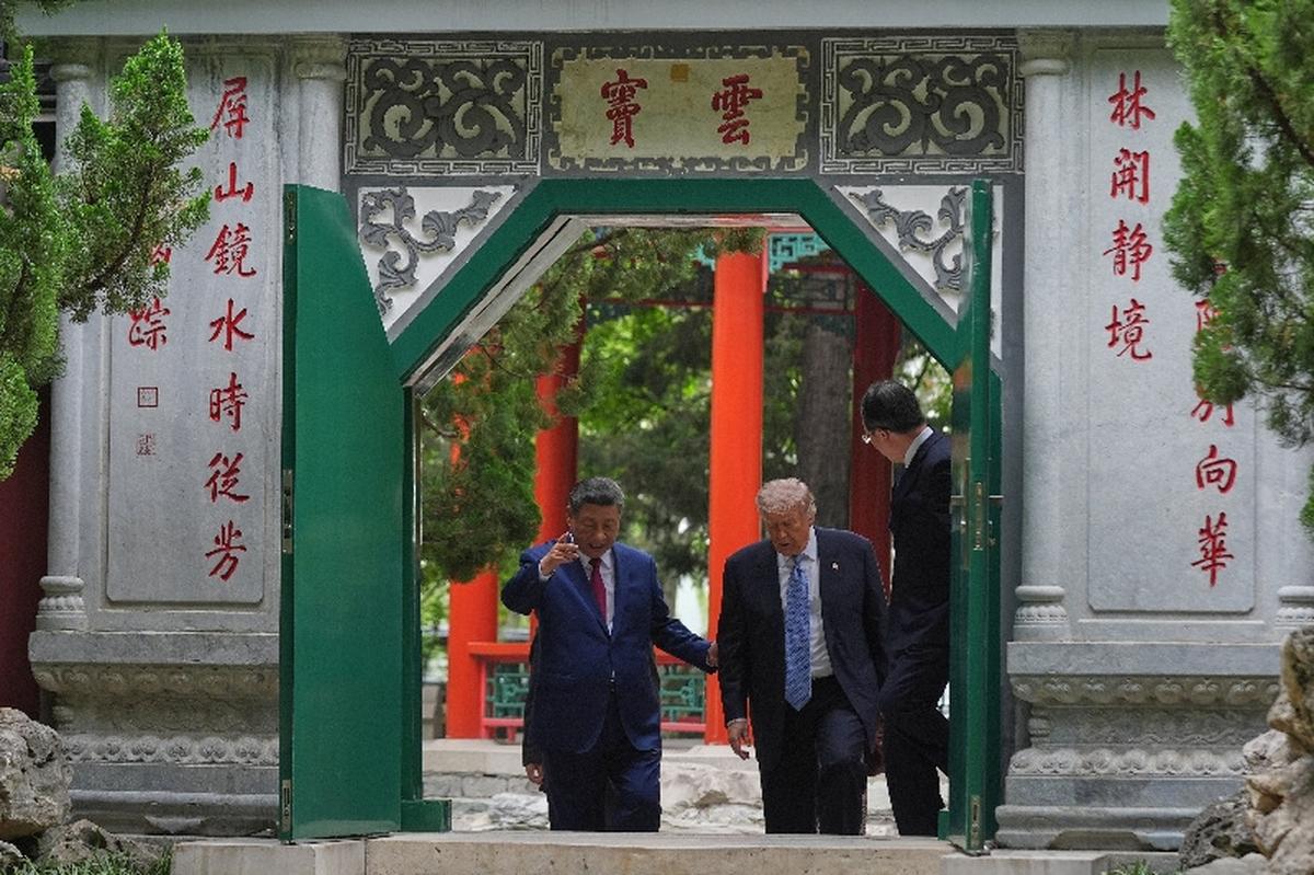 President Donald Trump walks with China’s President Xi Jinping at the Zhongnanhai leadership compound, Friday, May 15, 2026, in Beijing.  Mark Schiefelbein/Pool via REUTERS