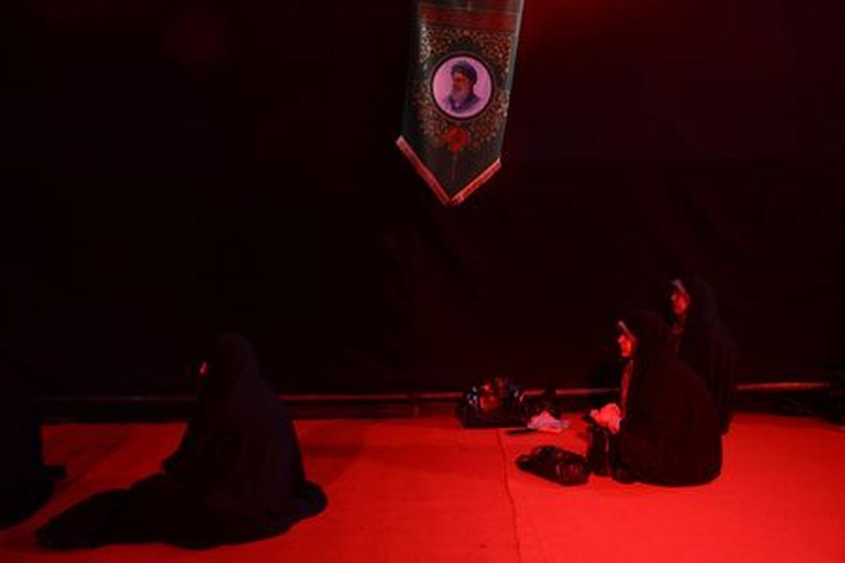 Iranian women pray next to a picture of the late Supreme Leader of Iran, Ayatollah Ali Khamenei, near his office in Tehran, Iran, May 6, 2026. Majid Asgaripour/WANA (West Asia News Agency) via REUTERS