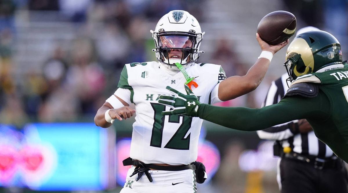 Oct 18, 2025; Fort Collins, Colorado, USA; Hawaii Rainbow Warriors quarterback Micah Alejado (12) is pressured by Colorado State Rams linebacker Paul Tangelo (52) in the first quarter at Sonny Lubick Field at Canvas Stadium. Mandatory Credit: Ron Chenoy-Imagn Images © Ron Chenoy-Imagn Images