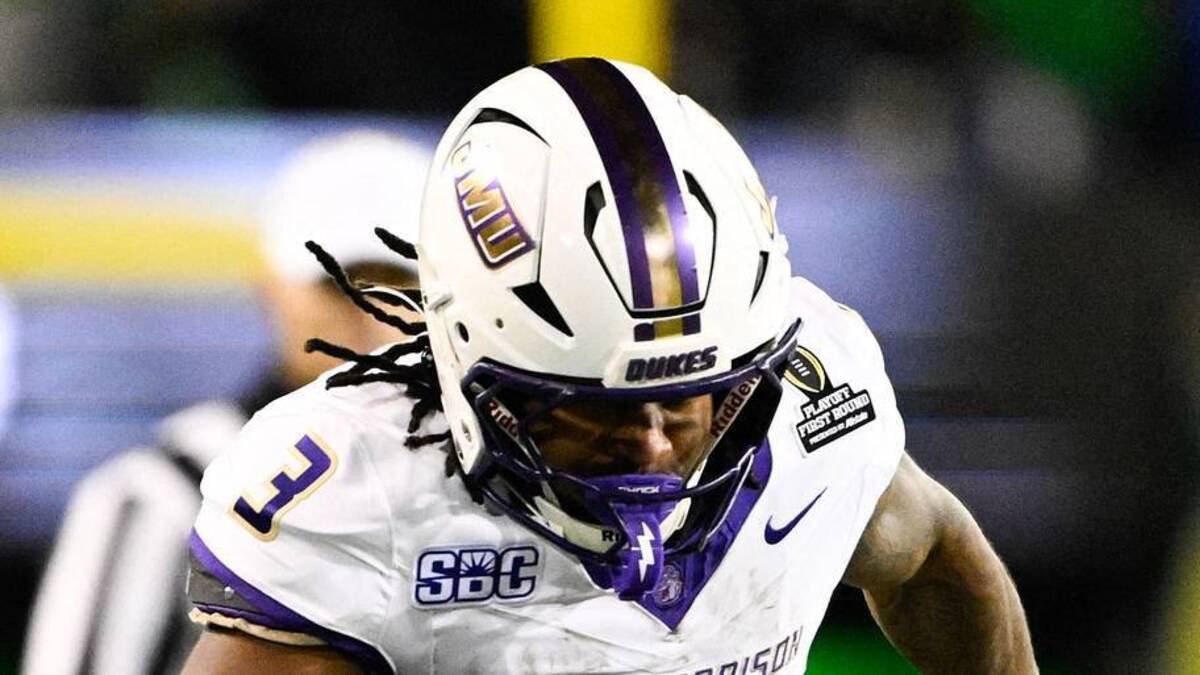  Dec 20, 2025; Eugene, OR, USA; James Madison Dukes running back Wayne Knight (3) rushes as Oregon Ducks defensive back Aaron Flowers (21) defends during the second quarter at Autzen Stadium. Mandatory Credit: Troy Wayrynen-Imagn Images | IMAGN IMAGES via Reuters Connect 